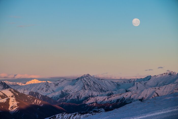 Full moon rising over Soho Basin at Cardrona Alpine Resort at sunrise