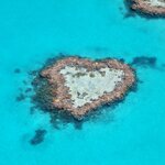 Take a scenic flight over the Whitsunday Islands to see Heart Reef, followed by a sunset sail