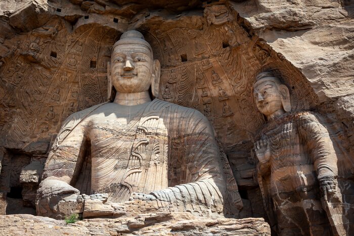 Visit Yungang Grottoes in Datong and explore the rock-cut caves adorned with over 51,000 Buddhist statues