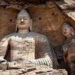 Visit Yungang Grottoes in Datong and explore the rock-cut caves adorned with over 51,000 Buddhist statues