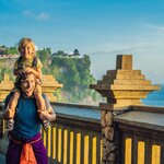 Look out over the ocean with the kids from Pura Luhur Uluwatu temple, Bali