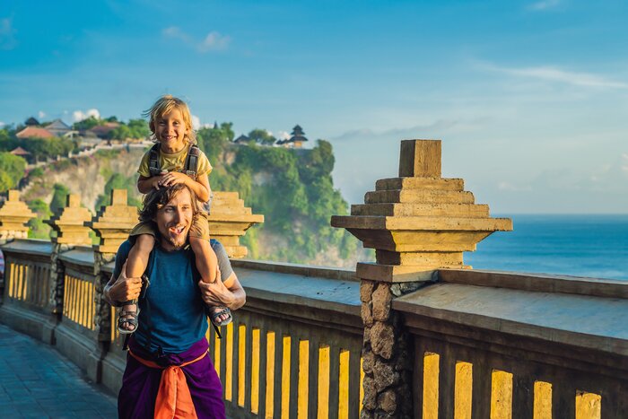 Look out over the ocean with the kids from Pura Luhur Uluwatu temple, Bali