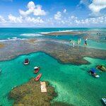 Colorful boats dotting the waters off Porto de Galinhas