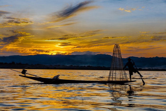 INLE LAKE, MYANMAR - DECEMBER 09, 2016 : Fisherman fishing at sunset on the Inle Lake Shan state in Myanmar (Burma)