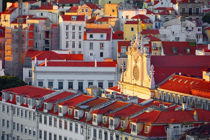 See the red-roofed buildings of historic Alfama neighborhood in Lisbon