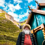 A Viking Village in Gudvangen with the village Chief standing beside his house. [Photo by redcharlie on Unsplash.]
