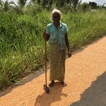 Lady drying rice on the road. | Photo taken by Sylvanna C