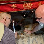At the Church of the Nativity in Bethlehem, we bought a candle from the presiding priest and lit it with one of the oil lamps at the altar that is built over the cave where religious historians believe that Jesus was born. | Photo taken by Rich W