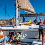 Sharing our Santorini Cruises catamaran dinner and sunset cruise with new found friends | Photo taken by David B