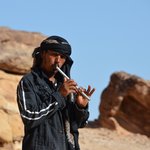 On the second morning, we hiked the "back way" up the rocks to view the magnificent Monastery at Petra.  Tariq was our guide for the hike up to the Monastery at Petra. Along the way, he would play his flute, which he made from a small metal pipe. He wore kohl (basically, a charcoal-based eyeliner) to emphasize and draw attention to his eyes. According to our regular driver, Akram, the trend of men wearing liner is popular among single males who hope to attract females’ attention – and was started by emulating the eyeliner that Johnny Depp wore in all his pirate movies.    - Petra, Jordan | Photo taken by Rich W