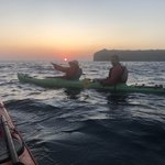 And as Maggie gestures, behold the fiery red sunset on the horizon. | Photo taken by Kris M