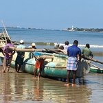 Pushing fishing boat up the beach. | Photo taken by Sylvanna C