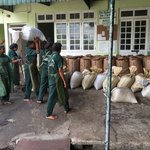 Factory workers moving 25kg bags of tea on their heads. | Photo taken by Sylvanna C