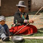 Our host, Alejandra and her grandson showing us how to braid the straw | Photo taken by Savana H