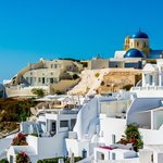 The dominant blue and yellow dome of the Oia town square | Photo taken by David B