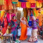 Women in the Fashion District of Jaipur, known as "The Pink City" because of its pink buildings. This fashion district of the city market sells colorful Sari material and decorations. | Photo taken by Jean M
