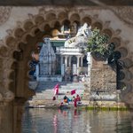 Women washing clothes on the lake. The town is within the walls of the ancient fort. The local king still lives in the palace on the lake. It was built centuries ago by his family, Udaipur | Photo taken by Jean M