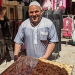 Many of the travel guidebooks and media advise caution for visitors to the West Bank, but we felt completely safe the entire time we were in Bethlehem. The Palestinian people were warm, friendly, and welcoming. Plus, the big tour groups do not often come into the West Bank, so the various sites are not overrun with tourists. Our terrific guide, Khadra Zreineh, seemed to know many of the vendors on the crowded market streets of Bethlehem. She bought us each one of the freshly baked (and still warm) date-filled pastries from this amazing baker. | Photo taken by Rich W