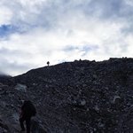 Trekking across one of the glaciers on the way to the Cho La Mountain Pass. Nothing but down on the other side of those rocks. | Photo taken by Anita P