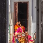 "The Wink" seen though the alley where a family relaxes on the step to their front door. | Photo taken by Jean M