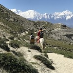 Alan on horseback with Himalayas  | Photo taken by Lisa D