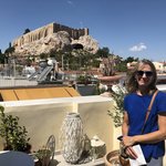 Kris on the top floor of our Home and Poetry hotel in the Plaka, the oldest neighborhood area of Athens, Greece. Behold our view of the Parthenon temple built on the Acropolis. | Photo taken by Kris M