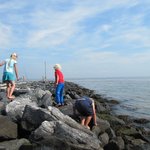 Children playing on the rocky shore of the North Sea